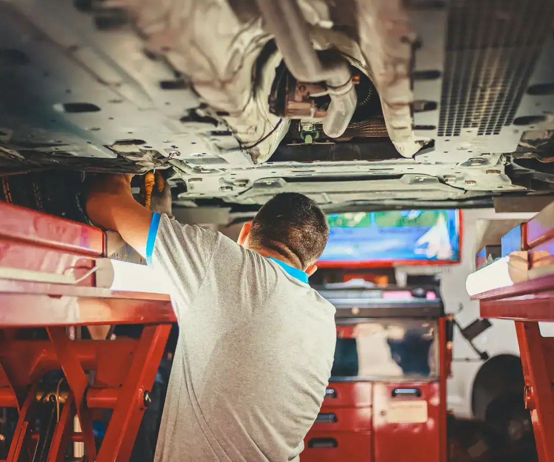 Mechanic working under a vehicle
