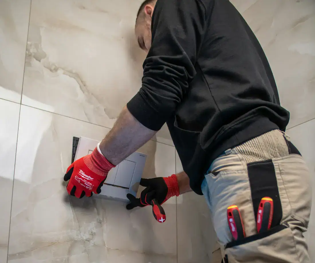 Plumber working on toilet system