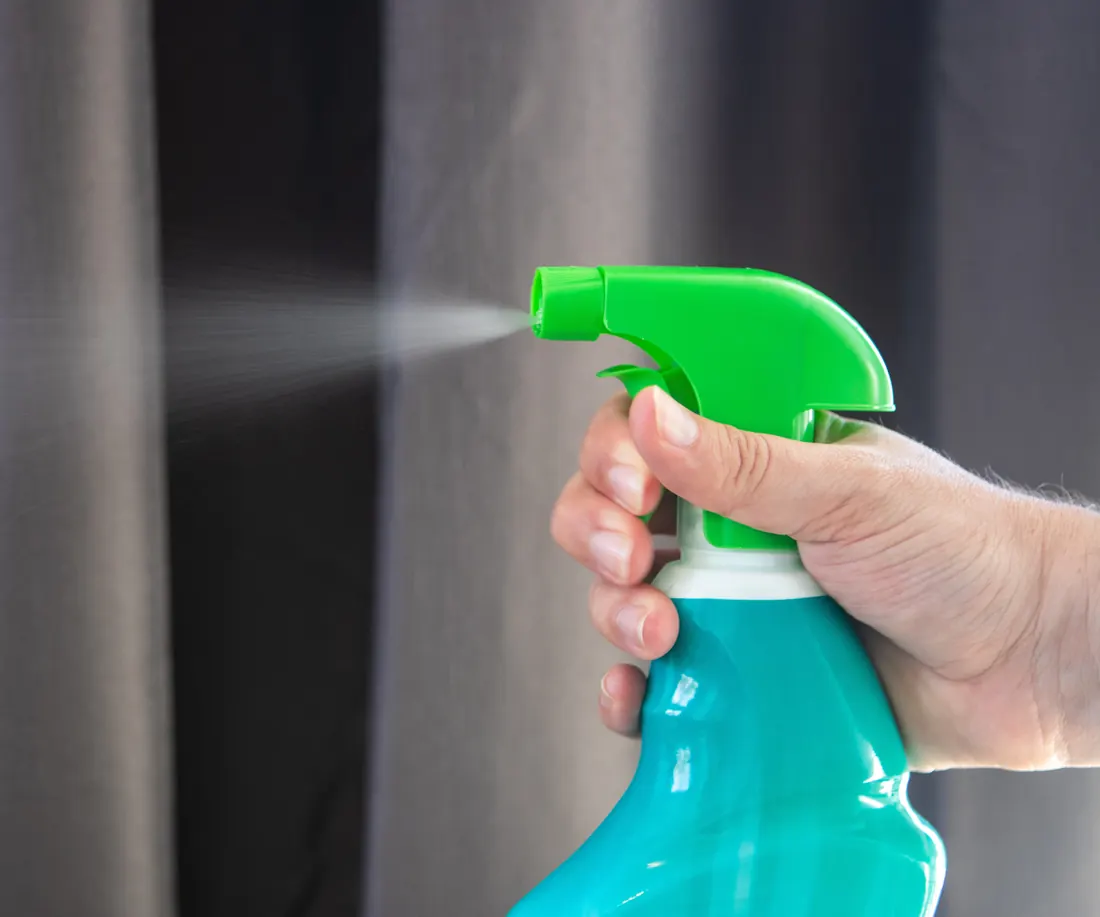 Cleaning spray bottle in use