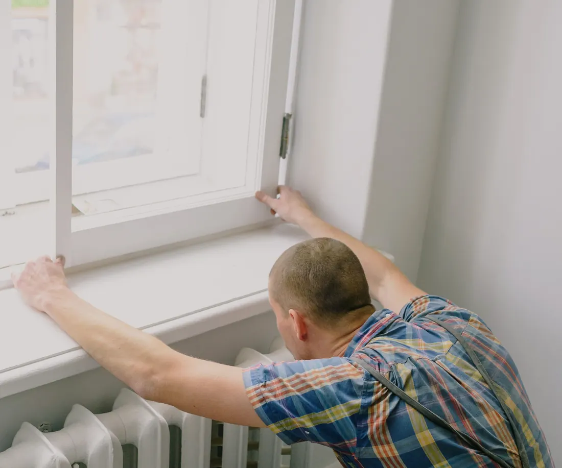 Handyman fixing a window frame