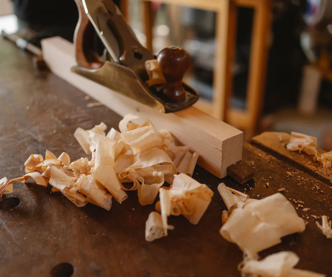 Hand plane and wood shavings on a joiner’s workbench