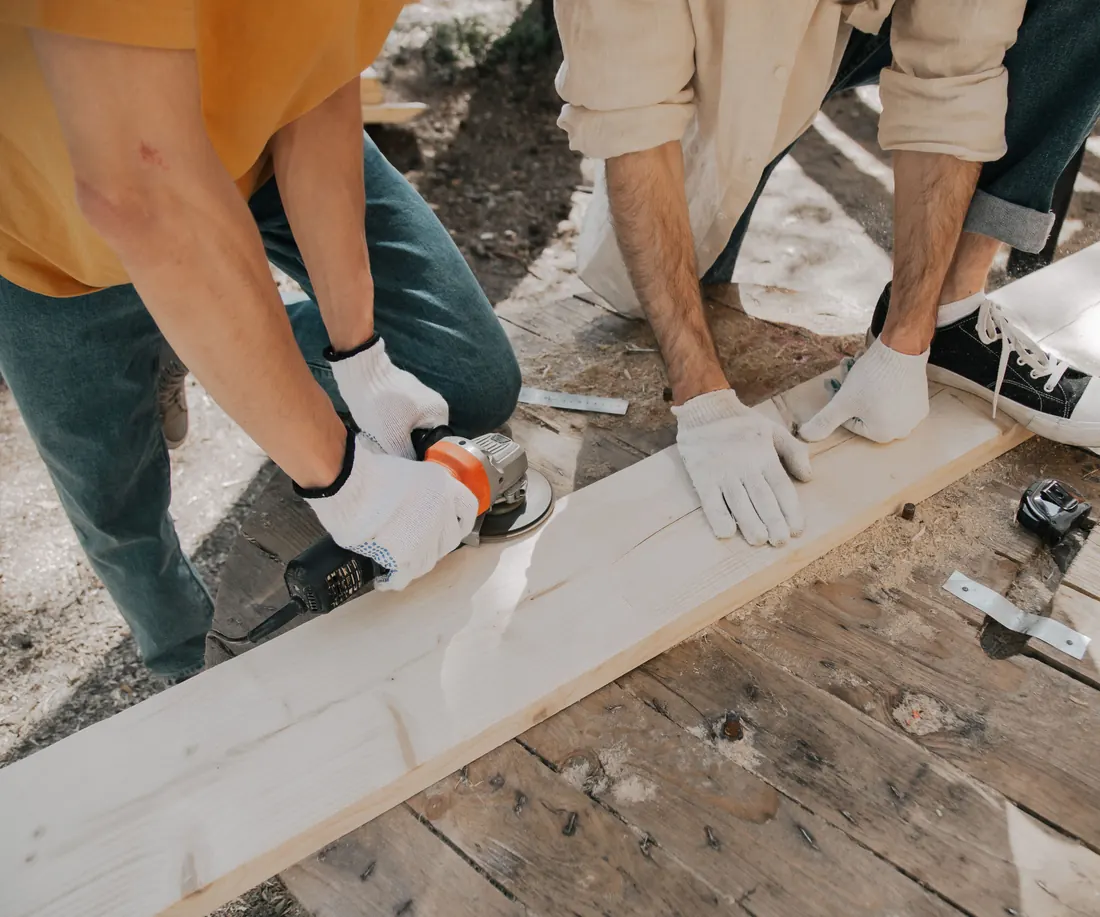 Two joiners cutting and shaping timber