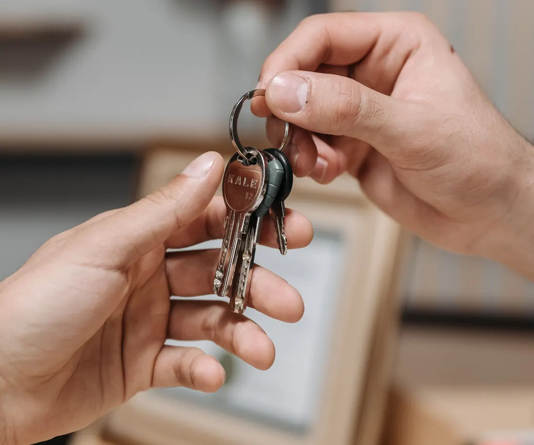 Set of house keys being handed over