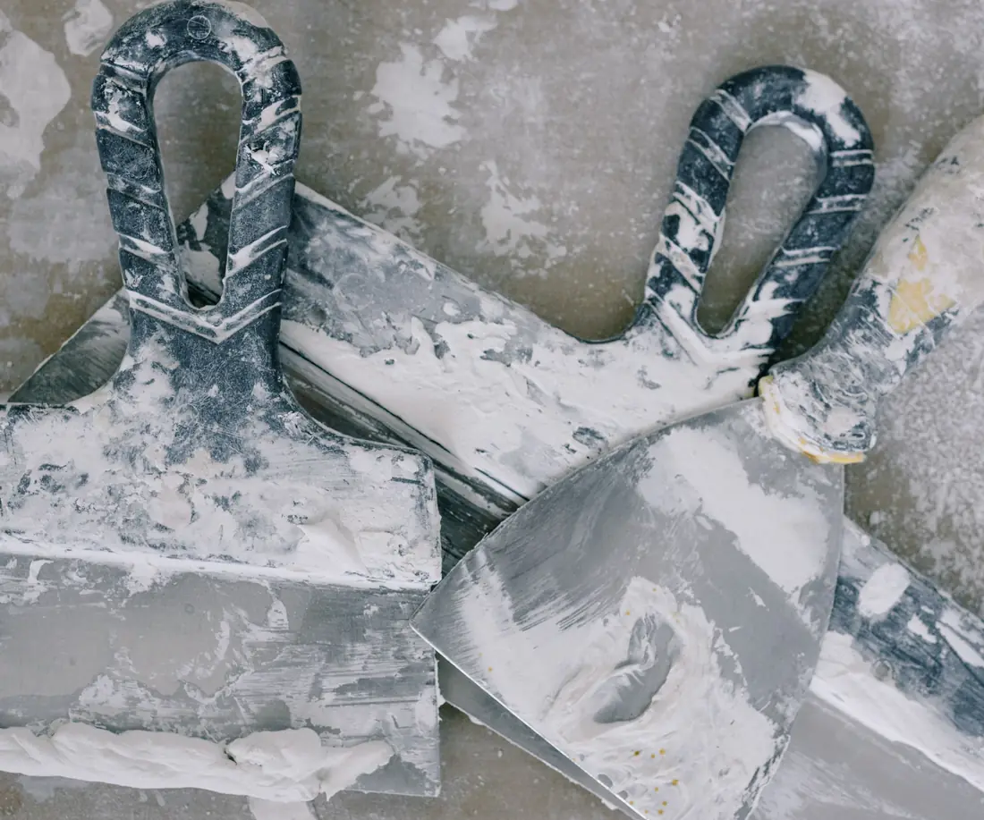 Plastering trowels and tools covered in plaster